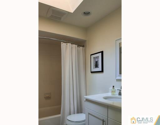 3406 Springbrook Drive Edison, NJ 08820 - Photo 9 of 10 a bathroom with a sink and a mirror