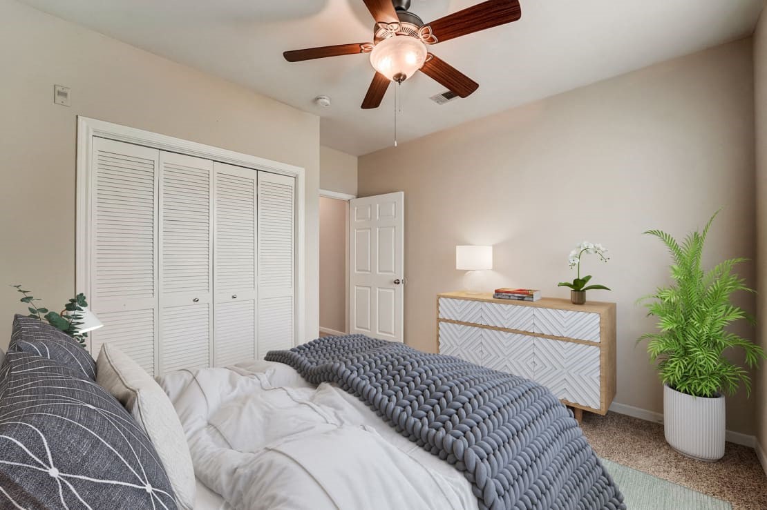 3101 Vista Drive, Unit A2 Rosenberg, TX 77471 - Photo 5 of 10 a bedroom with a bed and a potted plant