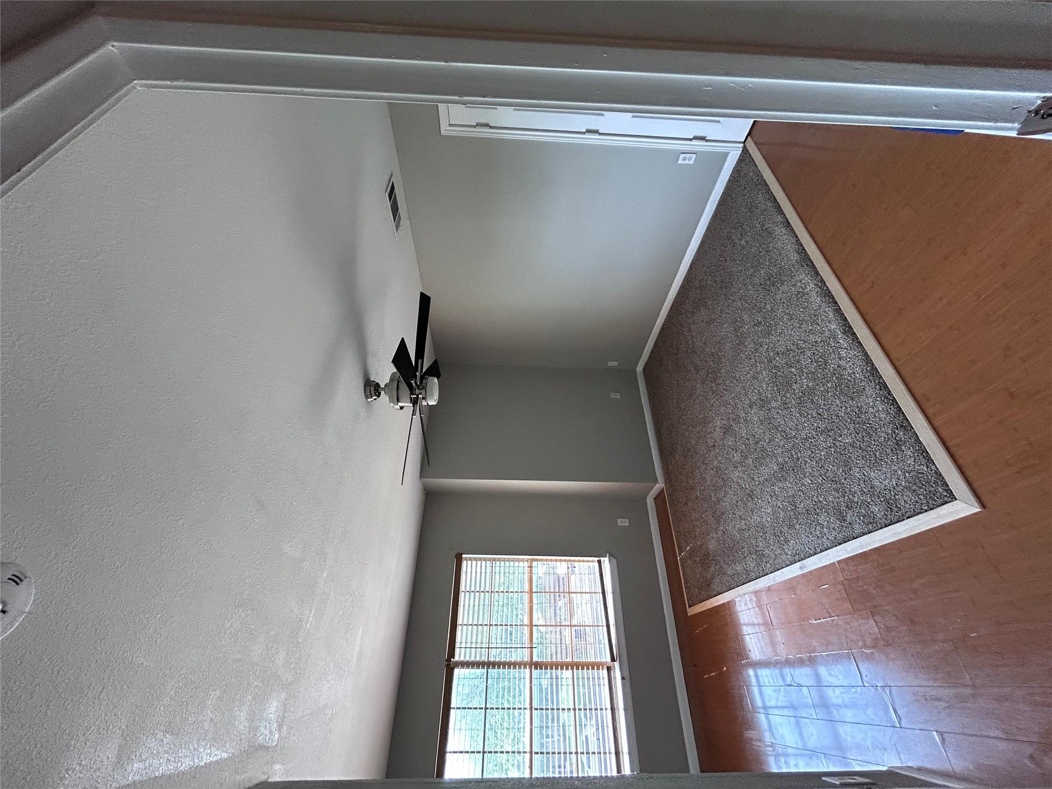 5708 Spring Meadow Road, Unit B Austin, TX 78744 - Photo 11 of 23 Empty room featuring wood finished floors, a textured ceiling, and a ceiling fan