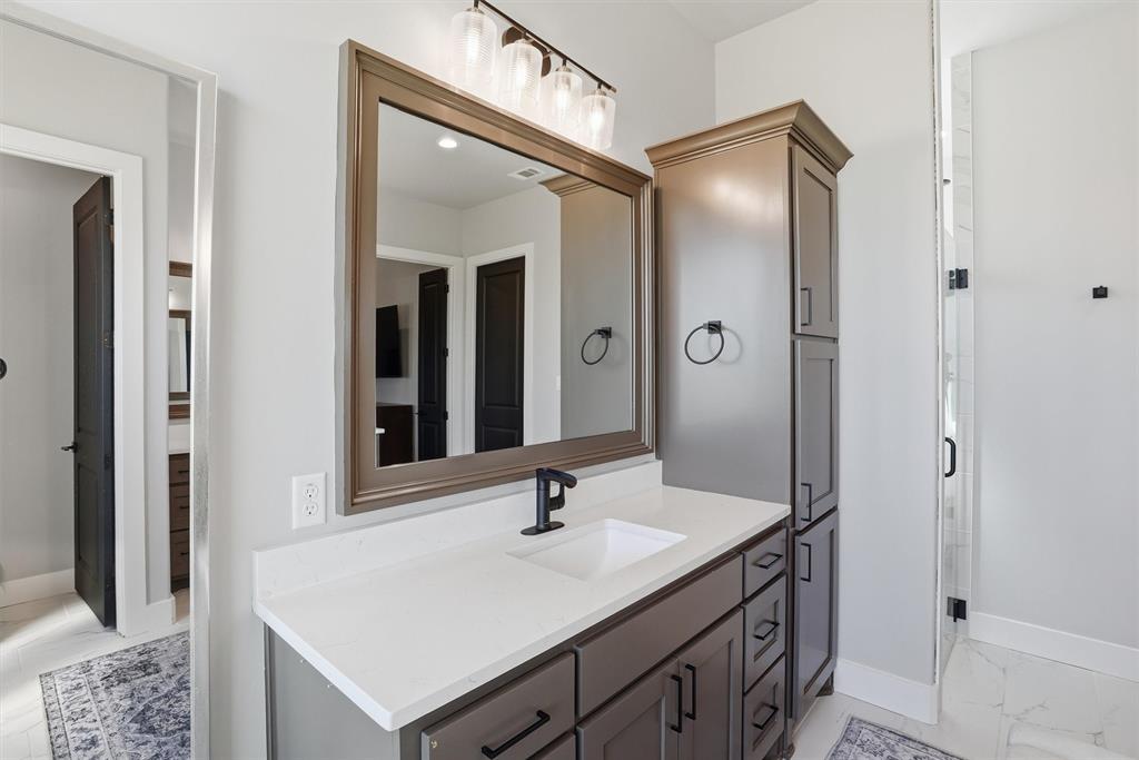 6620 Buffalo Ridge Circle Godley, TX 76044 - Photo 20 of 40 a bathroom with a sink vanity granite shower and a mirror
