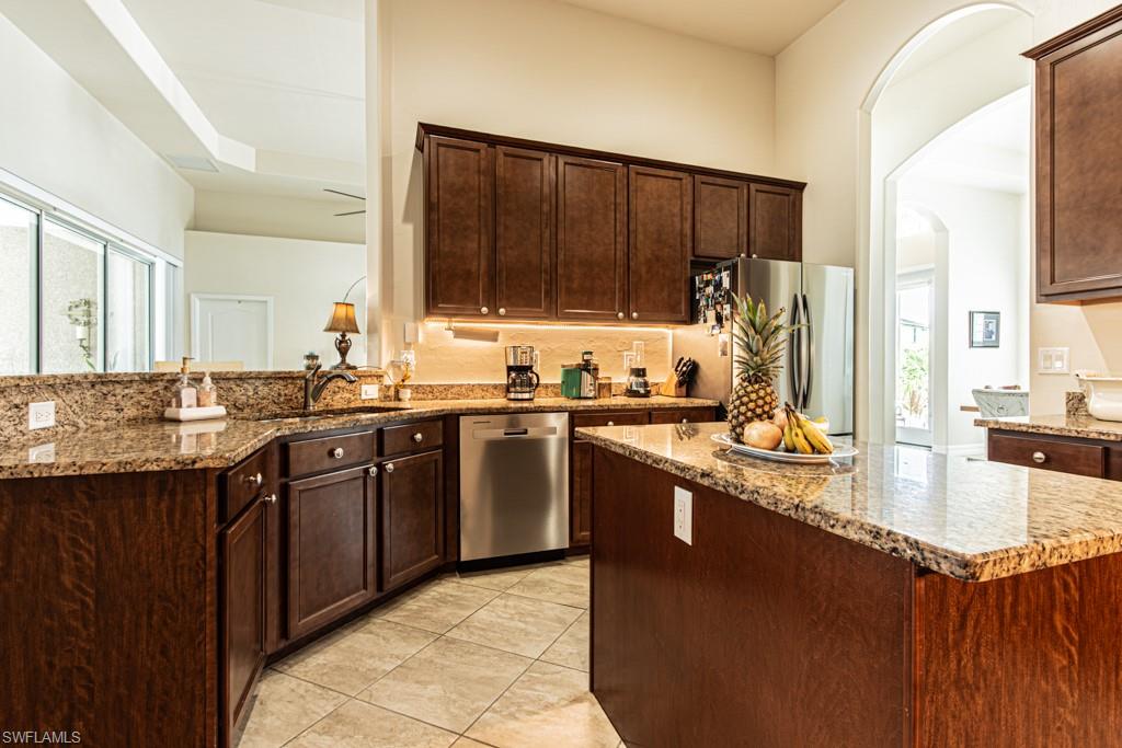 27151 Mora Road Bonita Springs, FL 34135 - Photo 13 of 50 a kitchen with stainless steel appliances granite countertop a sink stove and refrigerator