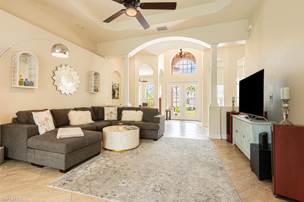 27151 Mora Road Bonita Springs, FL 34135 - Photo 16 of 50 a living room with furniture a flat screen tv and a large window