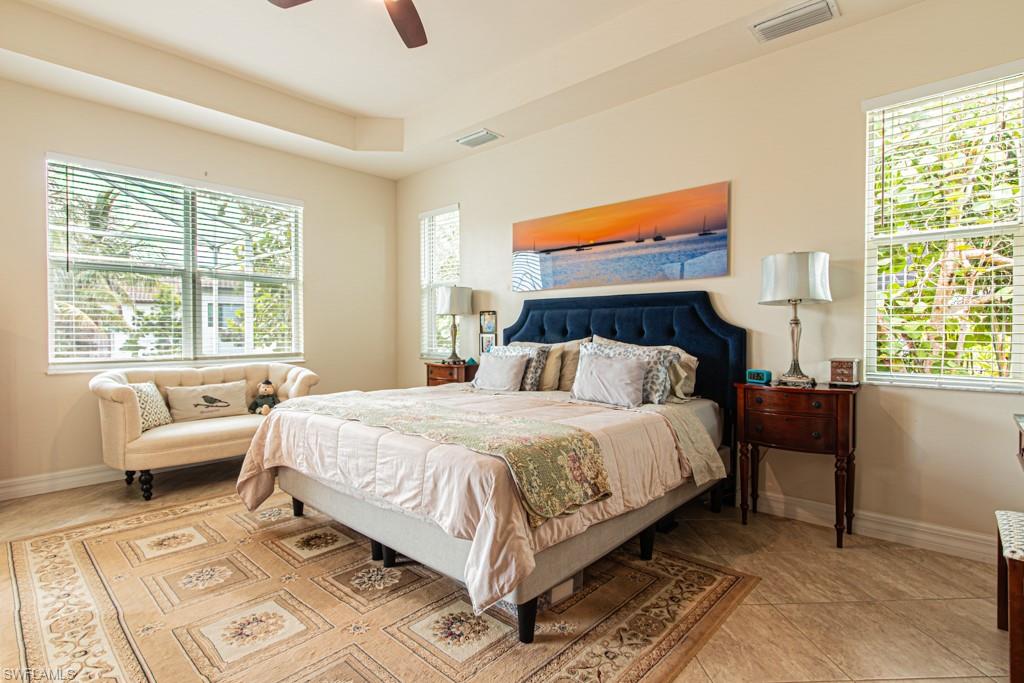 27151 Mora Road Bonita Springs, FL 34135 - Photo 21 of 50 a bed sitting in a bedroom next to a window