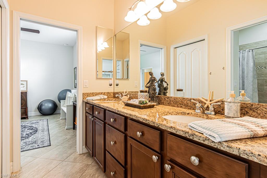27151 Mora Road Bonita Springs, FL 34135 - Photo 28 of 50 a bathroom with a granite countertop sink and a mirror