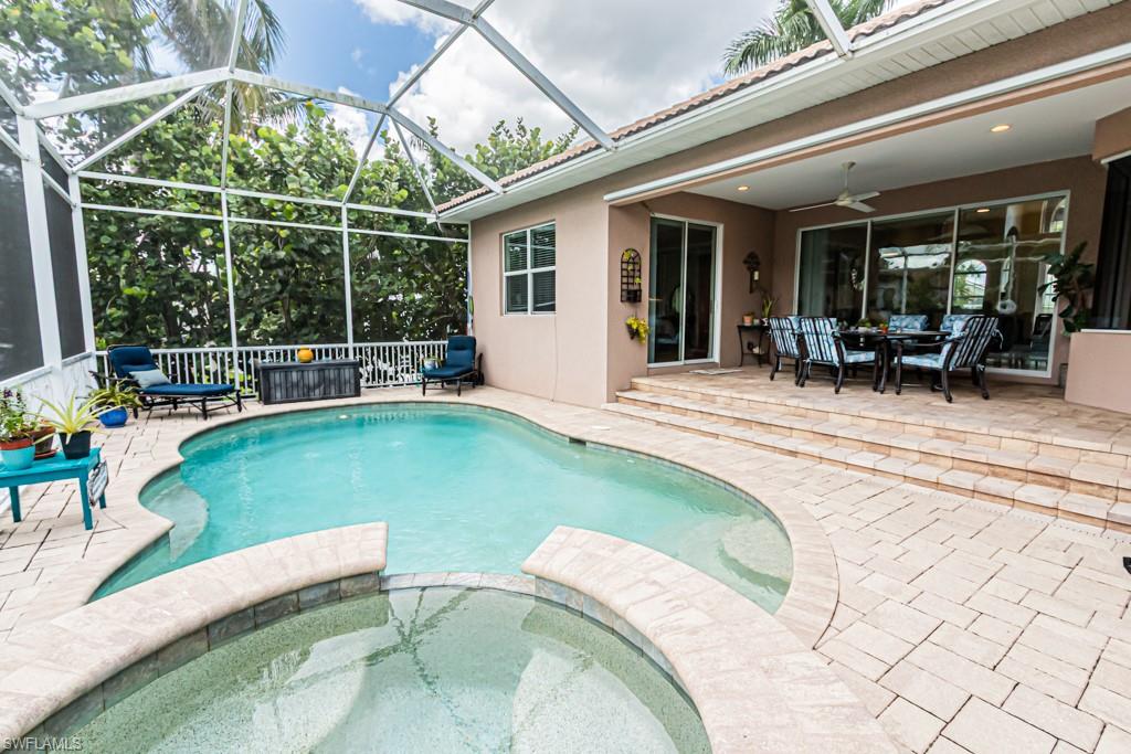 27151 Mora Road Bonita Springs, FL 34135 - Photo 42 of 50 a swimming pool with outdoor seating and yard