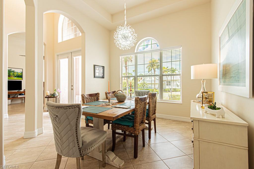 27151 Mora Road Bonita Springs, FL 34135 - Photo 7 of 50 a view of a dining room with furniture and a chandelier