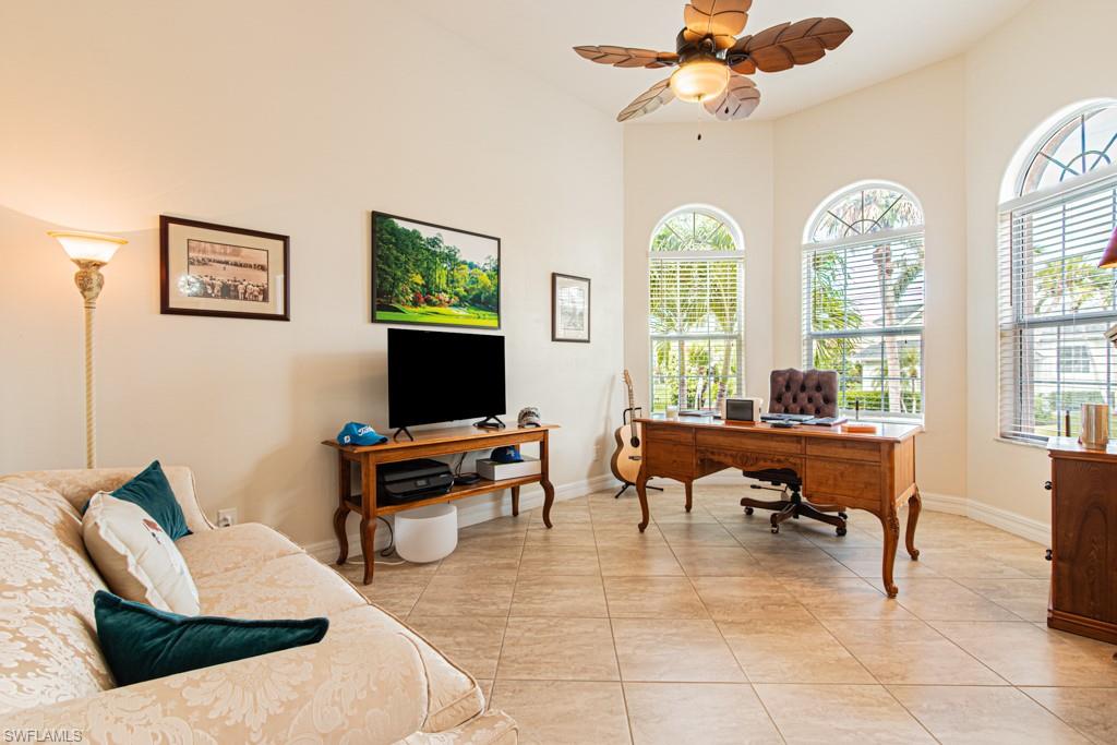 27151 Mora Road Bonita Springs, FL 34135 - Photo 9 of 50 a living room with furniture a chandelier fan and a window