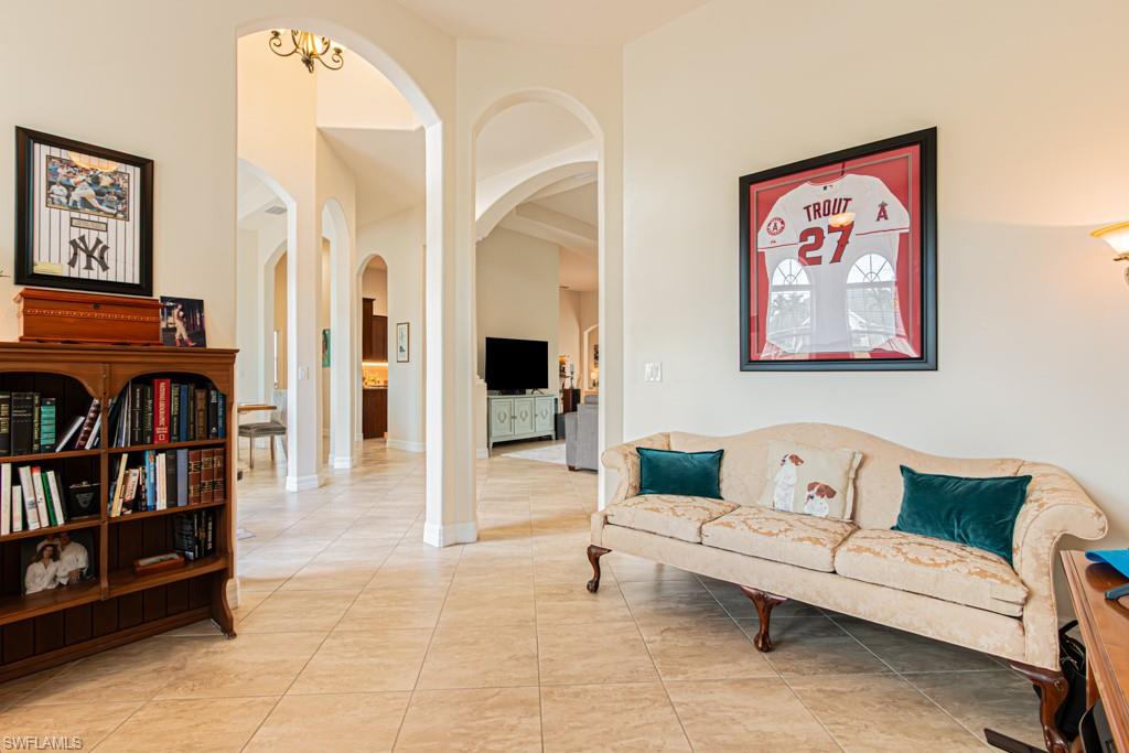 27151 Mora Road Bonita Springs, FL 34135 - Photo 10 of 50 a living room with furniture and a book shelf