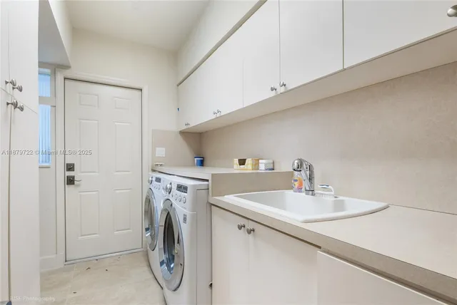 a utility room with sink washer and dryer