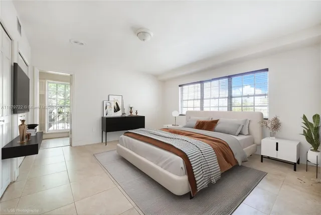 a bedroom with a bed and a large window