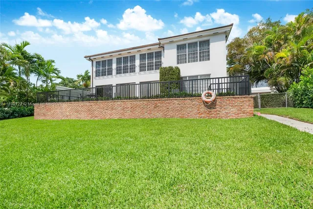 a view of a house with a yard and sitting area