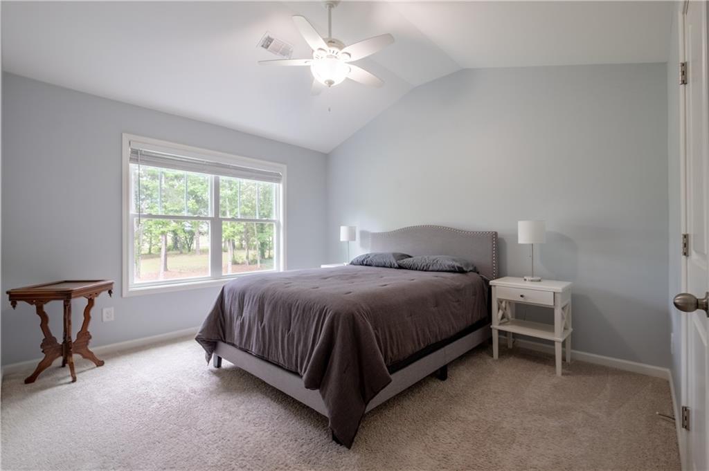 719 Fairview Road Brooks, GA 30205 - Photo 20 of 35 a spacious bedroom with a bed and a table in it
