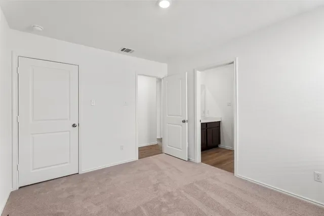 a bathroom with a bathtub shower sink mirror and toilet