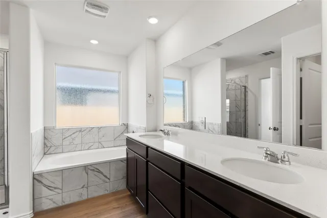 a bathroom with a double vanity sink mirror and double
