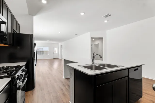 a front view of a house with yard and green space