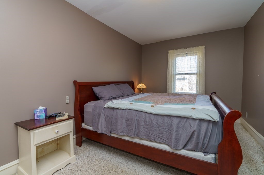 177 Lawton Street Fall River, MA 02721 - Photo 15 of 26 a bed sitting in a bedroom next to a window