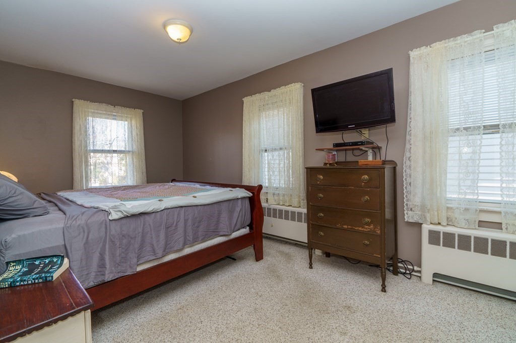 177 Lawton Street Fall River, MA 02721 - Photo 16 of 26 a bedroom with a bed and a flat screen tv