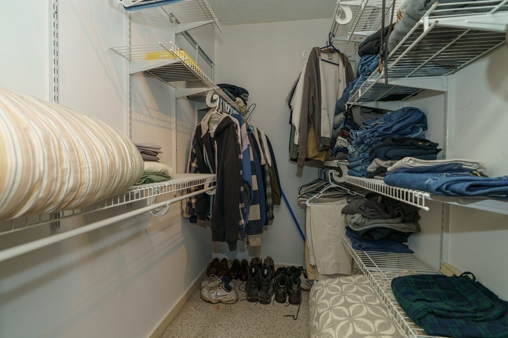 177 Lawton Street Fall River, MA 02721 - Photo 21 of 26 a view of walk in closet with clothes and shoes