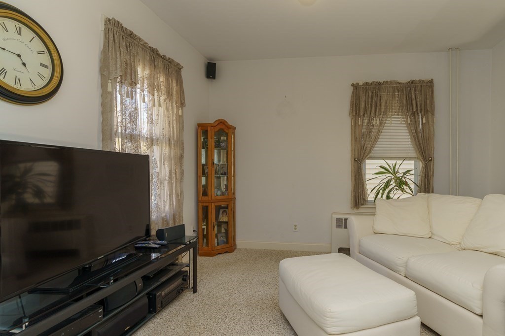 177 Lawton Street Fall River, MA 02721 - Photo 5 of 26 a living room with furniture a flat screen tv and a window