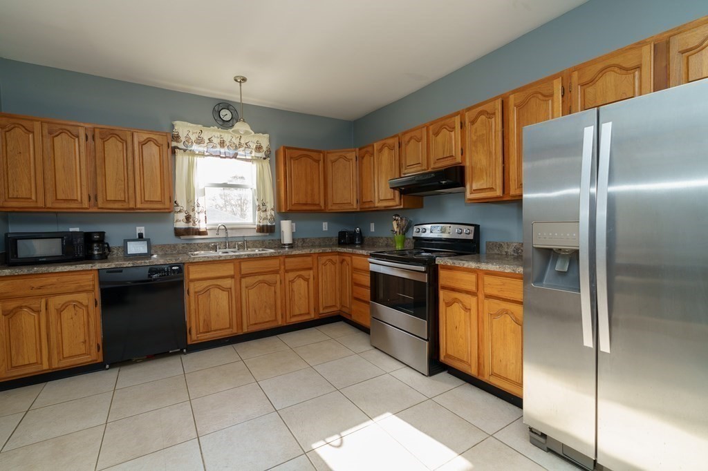 177 Lawton Street Fall River, MA 02721 - Photo 6 of 26 a kitchen with stainless steel appliances granite countertop a stove sink and cabinets