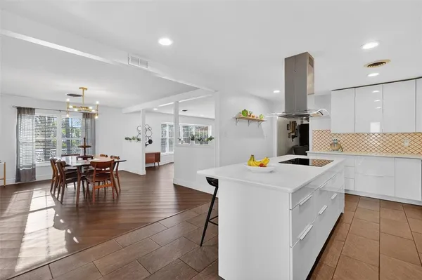 a large kitchen with a stove a refrigerator and a sink