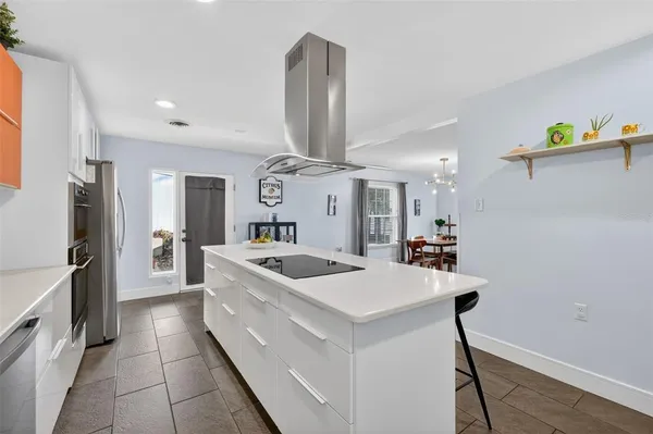 a kitchen with stainless steel appliances granite countertop a sink and a refrigerator
