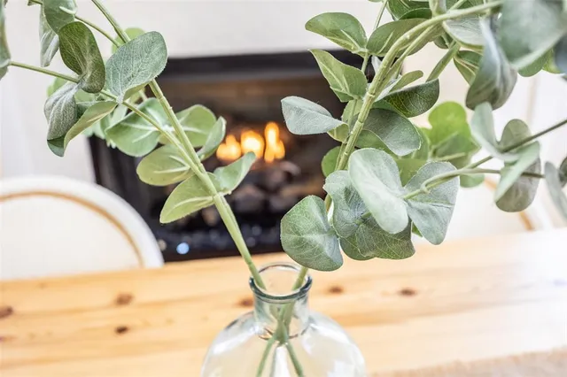 a very nice looking dining room with a large window and chandelier