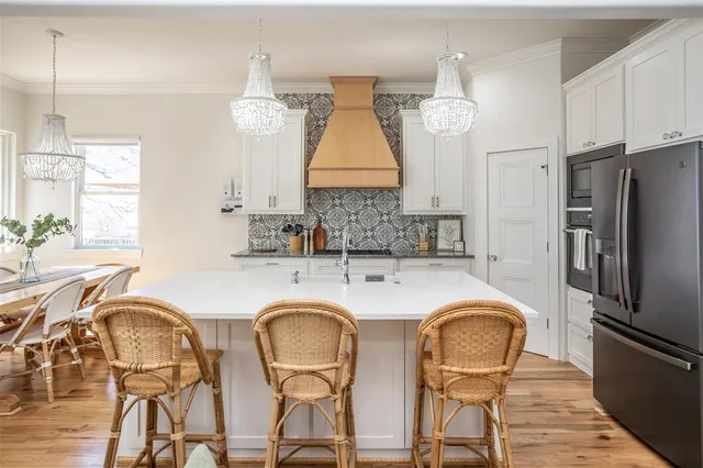 a kitchen with stainless steel appliances a refrigerator stove and microwave