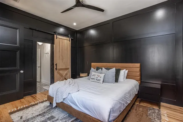 a en suite bathroom with a granite countertop sink and a mirror