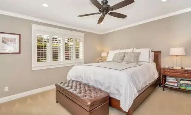 a bedroom with a bed and window