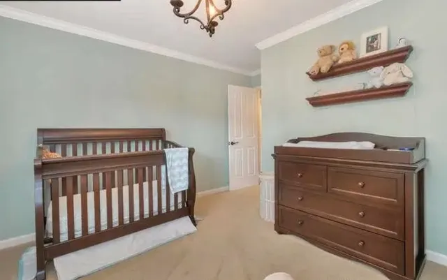 a bedroom with a bed and painting on the wall