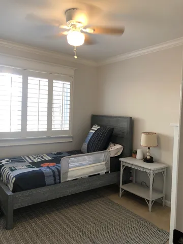 a bedroom with furniture and a window
