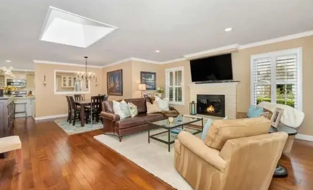 a living room with furniture fireplace and a flat screen tv