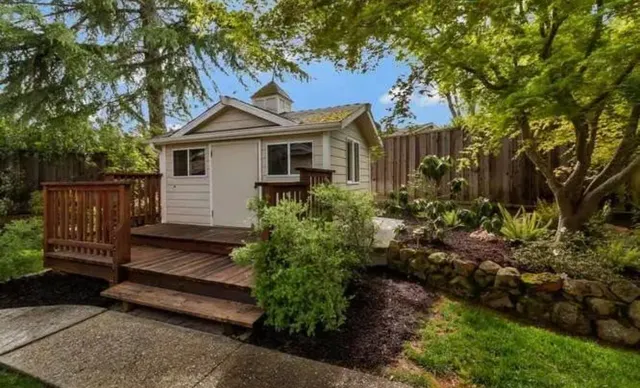 a front view of a house with a garden