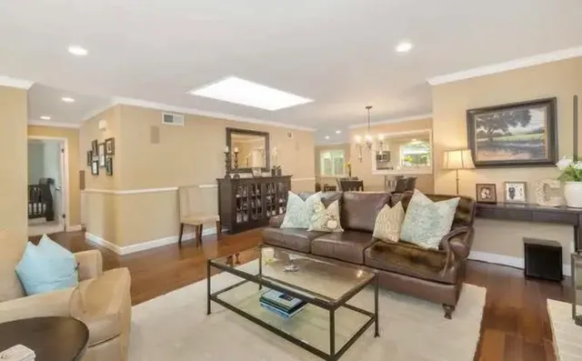 a living room with furniture and kitchen view