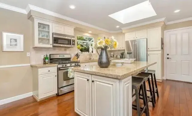 a kitchen with a sink a stove and cabinets