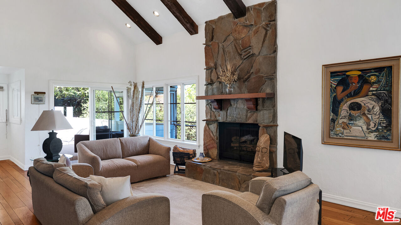 2312 Kimridge Road Beverly Hills, CA 90210 - Photo 54 of 60 a living room with furniture and a fireplace