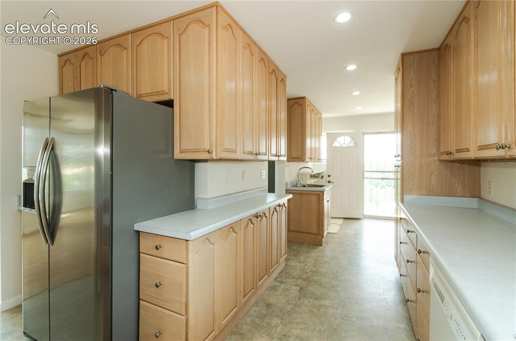 4710 Limestone Road Monument, CO 80132 - Photo 14 of 50 a kitchen with stainless steel appliances a refrigerator sink and cabinets