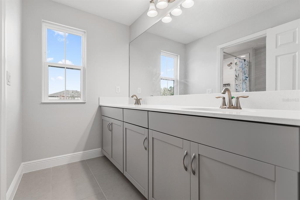14671 Horse Trot Road Lithia, FL 33547 - Photo 23 of 40 a bathroom with a double vanity sink a mirror and a vanity
