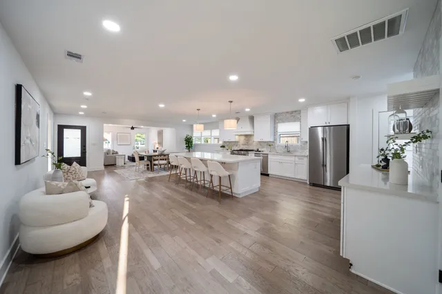 a kitchen with white cabinets and white appliances