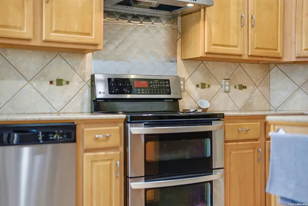 a kitchen with appliances a microwave and cabinets