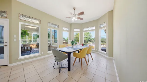 a dining room with furniture window and wooden floor