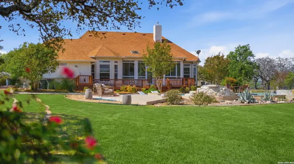 a view of a house with backyard porch and sitting area