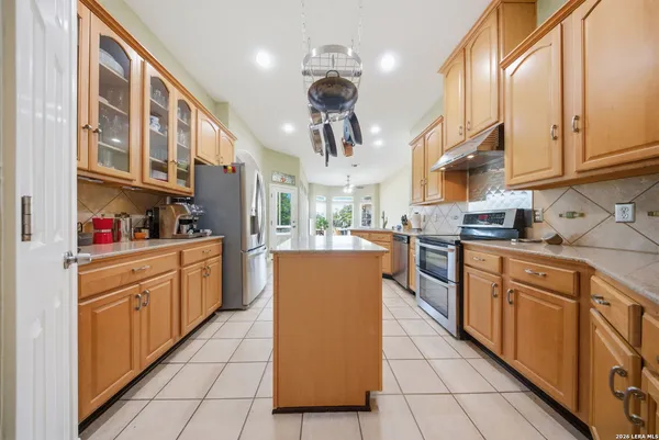 a stove top oven sitting inside of a kitchen