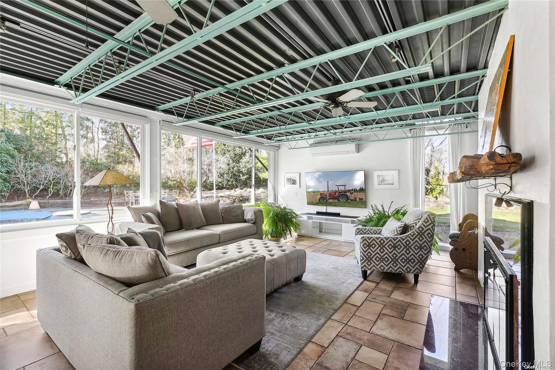 162 Middle Line Southampton, NY 11968 - Photo 4 of 15 a living room with furniture and a floor to ceiling window