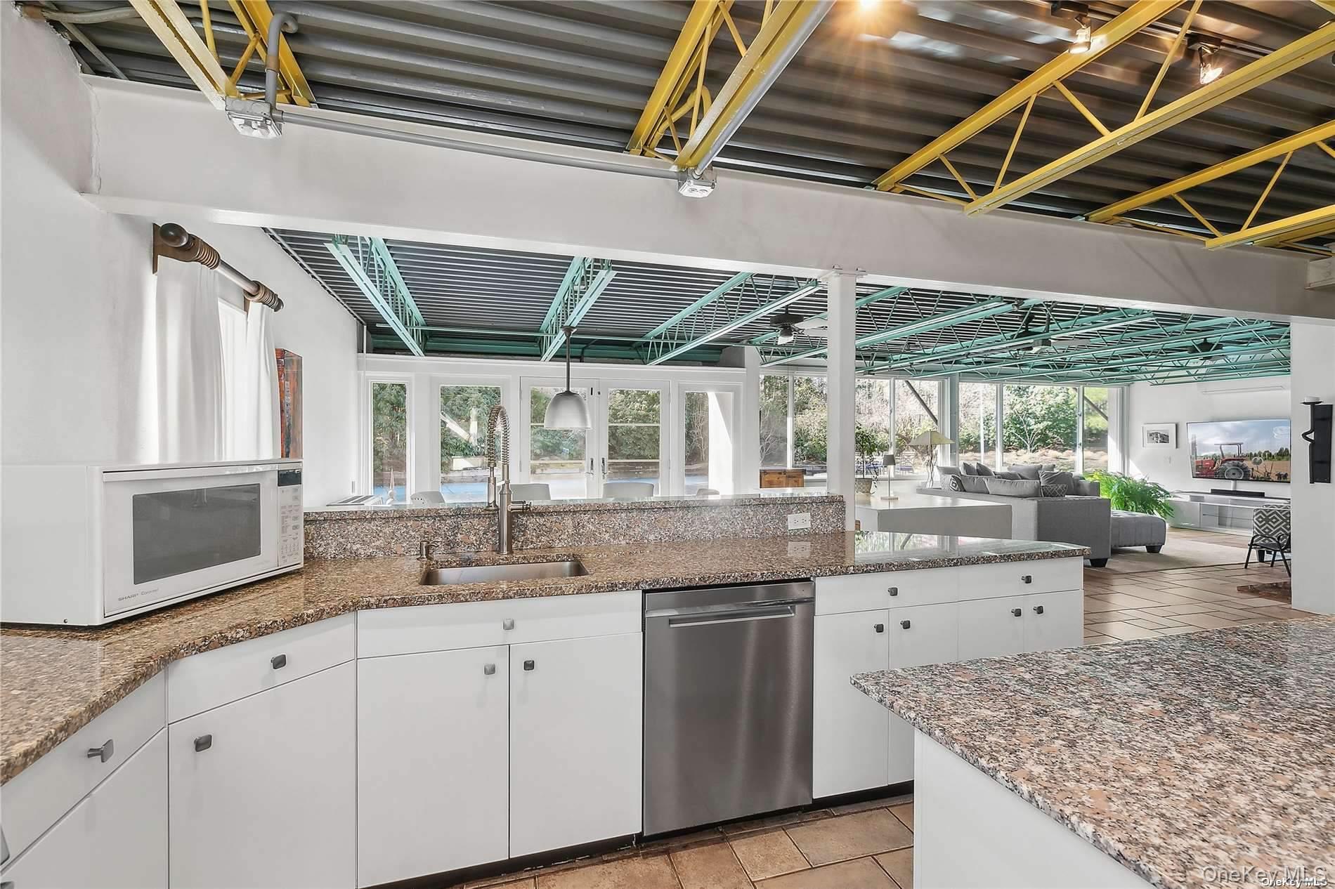 162 Middle Line Southampton, NY 11968 - Photo 8 of 15 a kitchen with granite countertop a sink a counter space appliances and cabinets