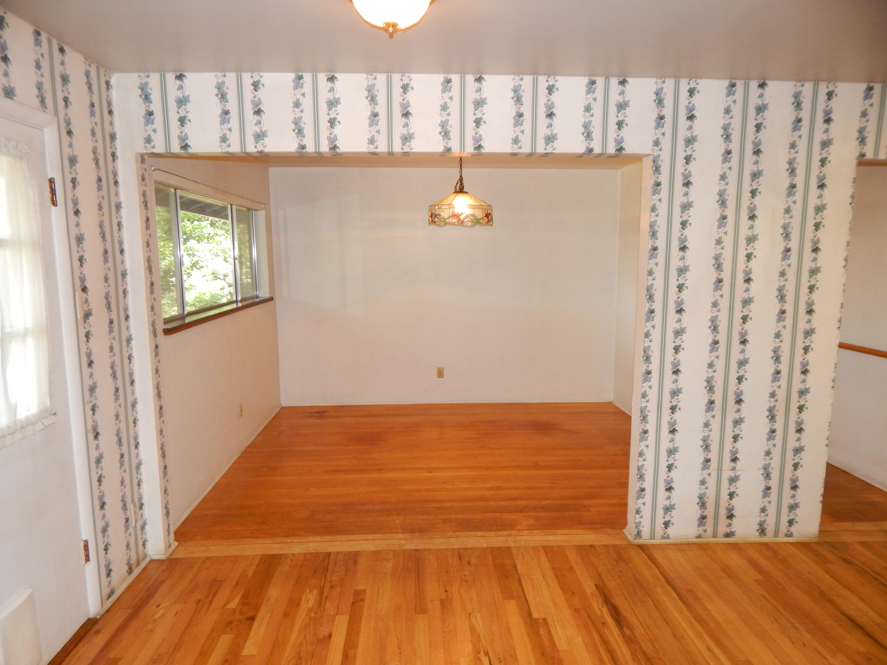 6460 Riverside Drive Redding, CA 96001 - Photo 11 of 81 a view of a room with wooden floor and window