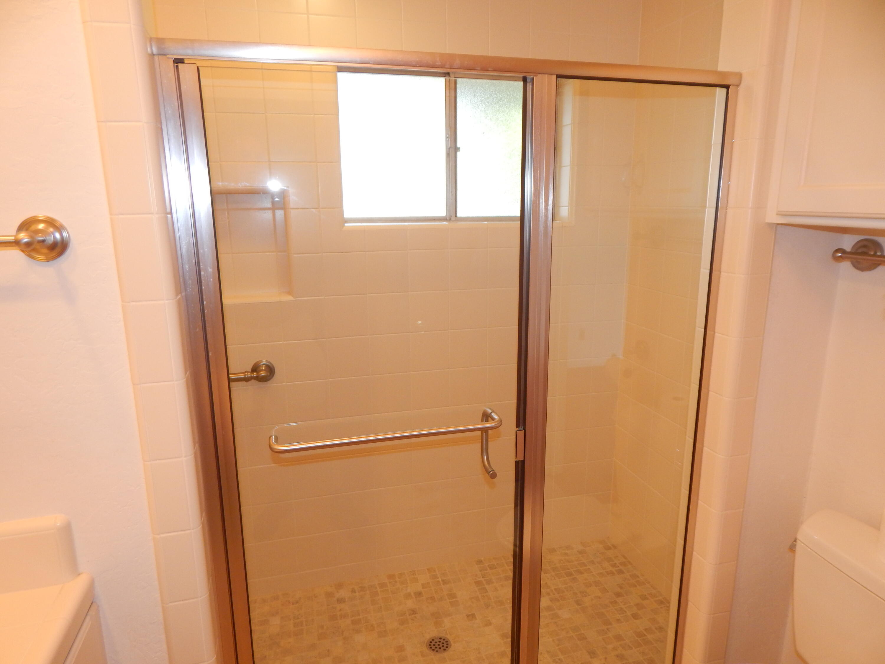 6460 Riverside Drive Redding, CA 96001 - Photo 39 of 81 a bathroom with a glass shower door