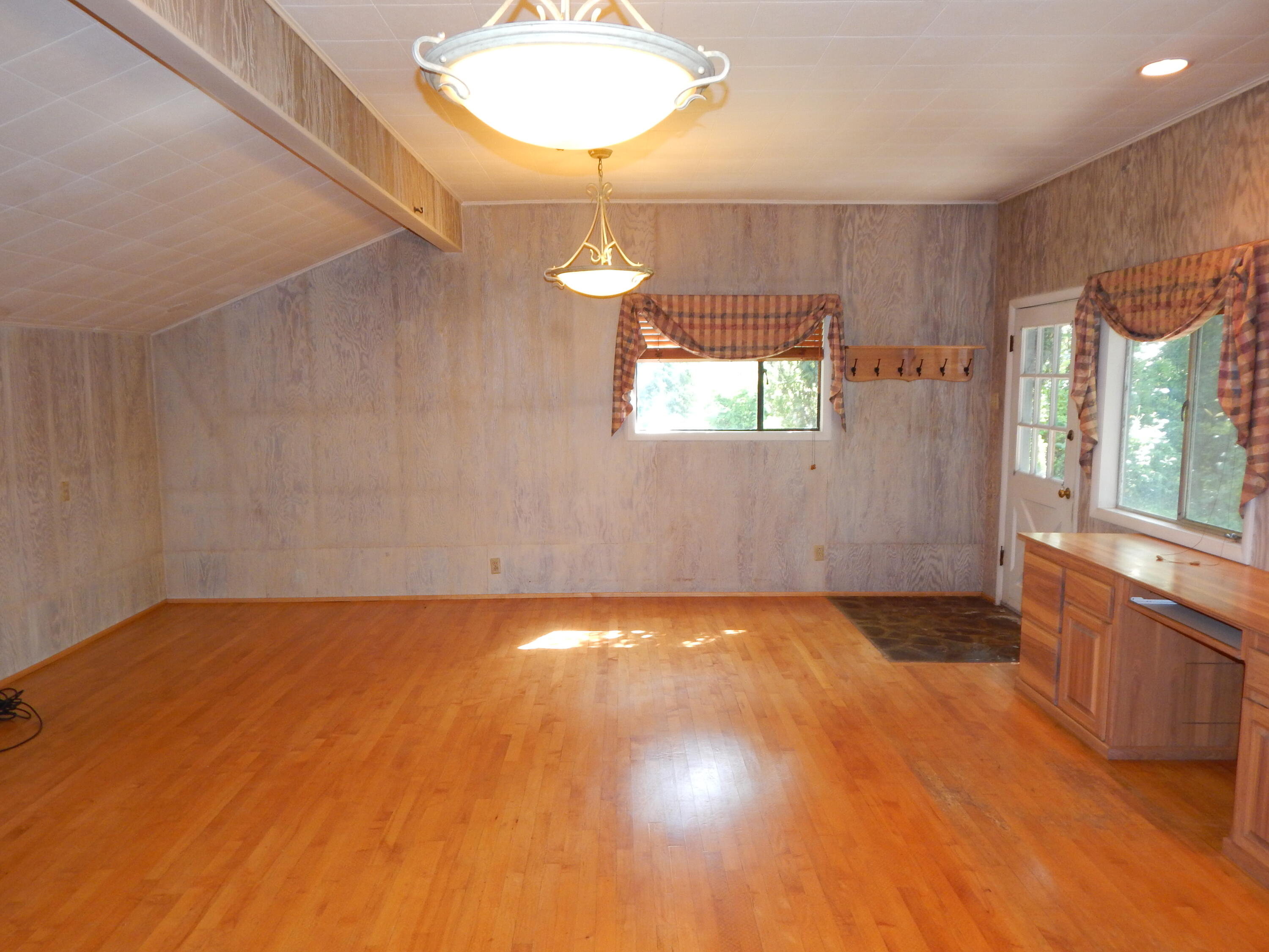 6460 Riverside Drive Redding, CA 96001 - Photo 64 of 81 a view of an empty room with window and wooden floor