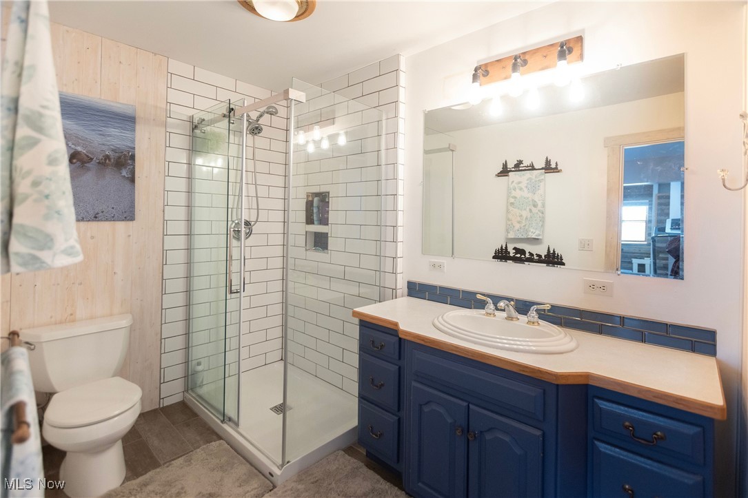 253 Sunset Road Avon Lake, OH 44012 - Photo 21 of 33 Full bathroom featuring toilet, a shower stall, and vanity